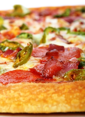 Featured is a photo of a yummy looking dressed pizza by an unknown UK photographer.  Looks like pepperoni and peppers to me!